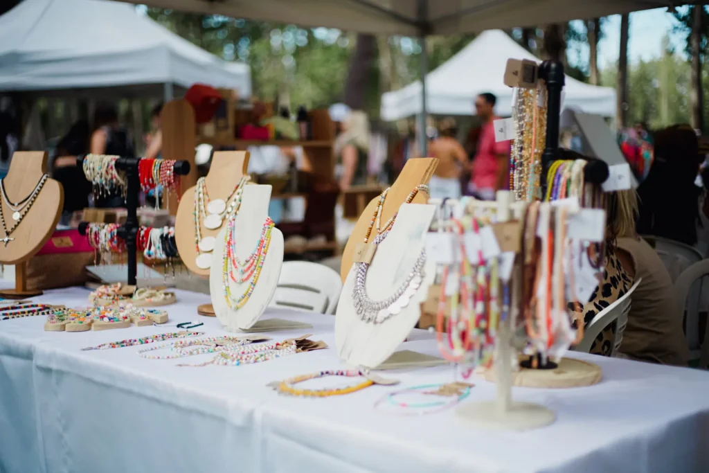 Peregian Beach Markets with local stalls, visitors and park setting near the beach