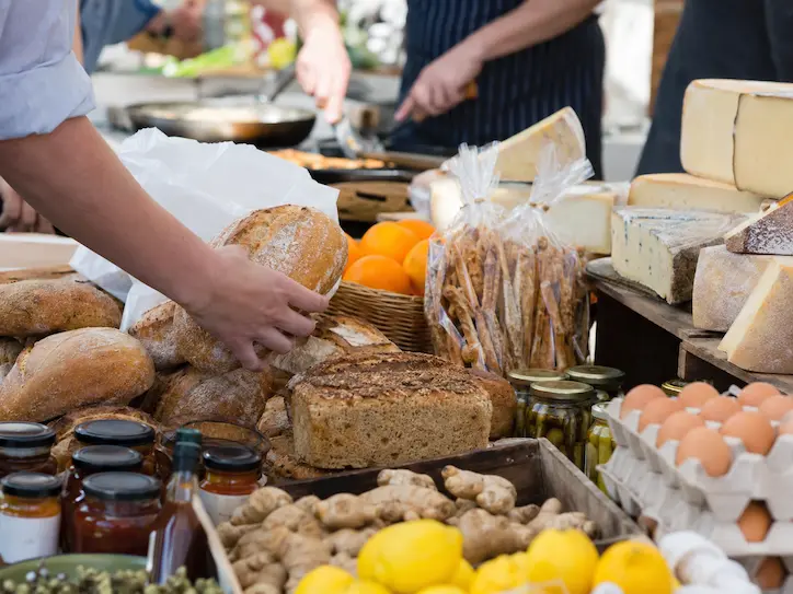 Local produce stall at a Mary Valley food event with artisan bread, cheese, eggs, preserves and fresh ingredients in regional Queensland.